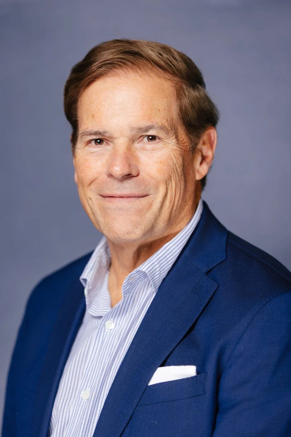 Businessman with glasses smiling during a professional branding headshot session